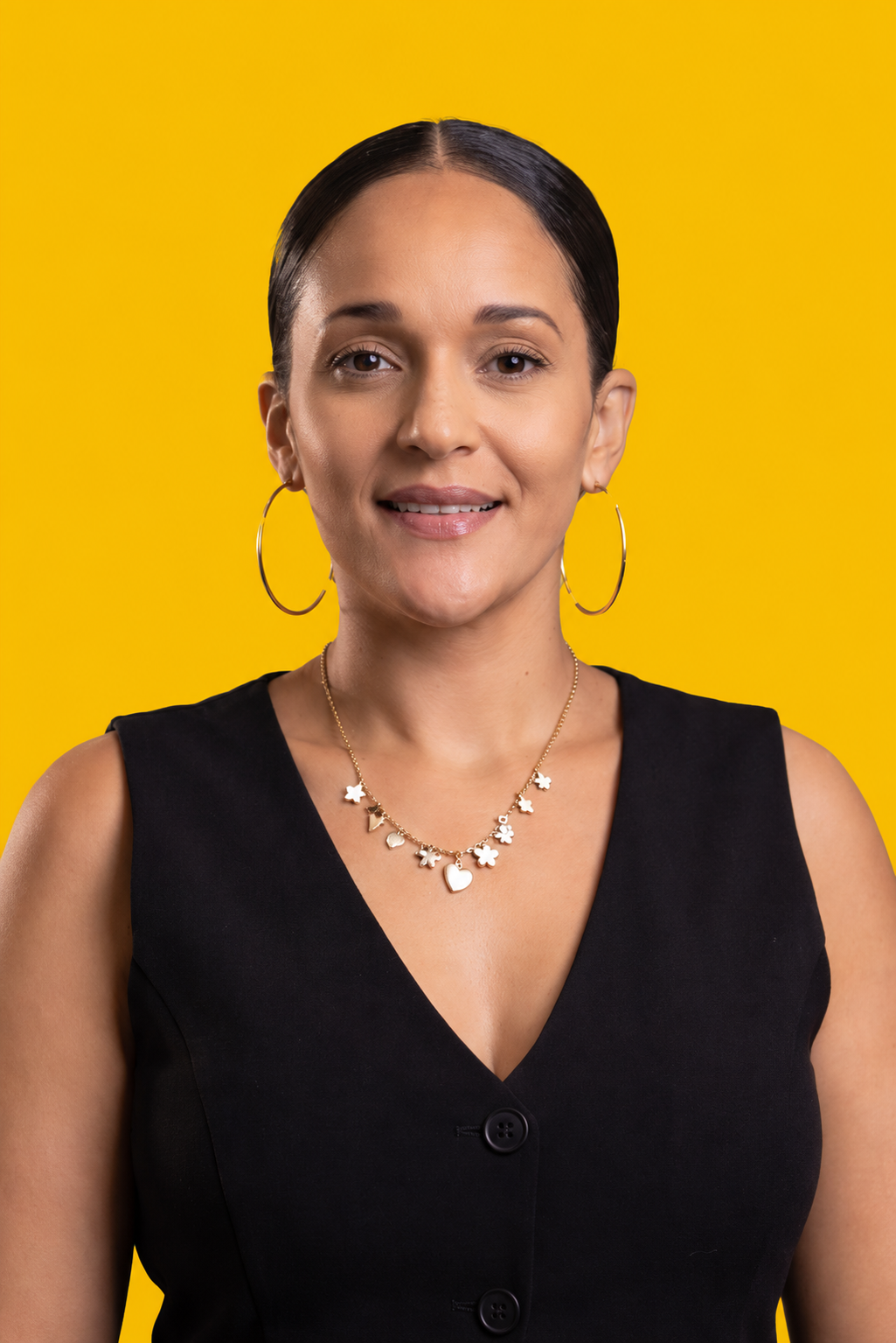 Emmys Velazquez, REALTOR®, professional headshot on a gold background